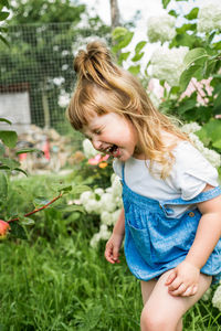 Cute girl smiling with plants in background