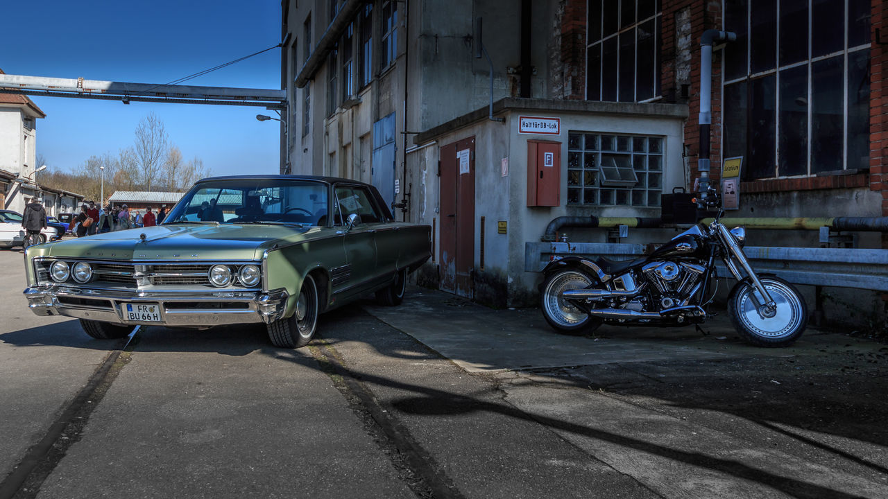 transportation, mode of transportation, land vehicle, motor vehicle, car, architecture, city, building exterior, built structure, road, street, vintage car, retro styled, building, day, outdoors, damaged, no people, stationary, garage