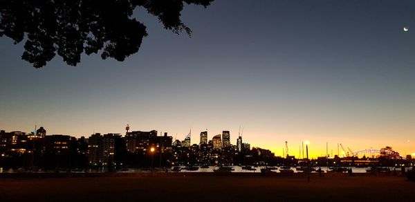 Silhouette buildings against sky during sunset