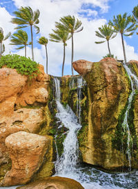 Scenic view of waterfall against sky