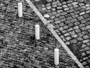 High angle view of bollards on sidewalk