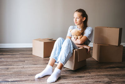 Portrait of young woman sitting on sofa at home