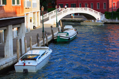 Bridge over boats on grand canal in sunny day
