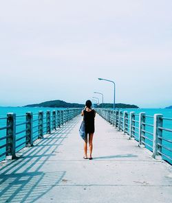 Full length of man standing on beach against clear sky