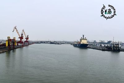 Commercial dock by sea against sky