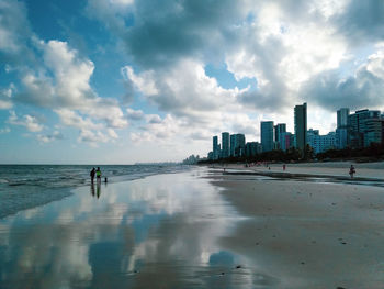 Panoramic view of sea and buildings against sky