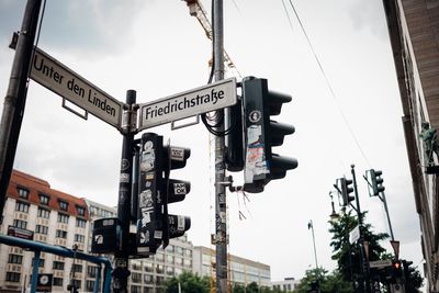 Low angle view of road signs against sky