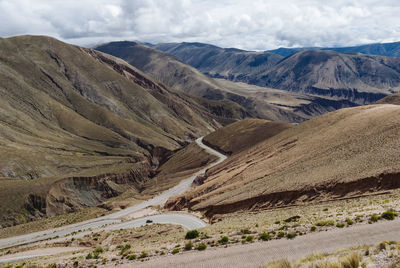 Scenic view of mountains against cloudy sky