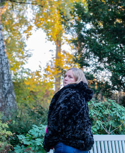 Mature woman in warm clothes standing outdoors