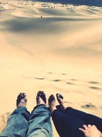 Low section of people relaxing on beach