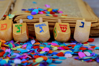 Close-up of wooden toy blocks with colorful confetti on table