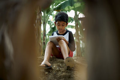 Portrait of teenage girl sitting outdoors