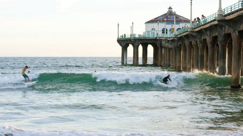 Two people surfing in the sea