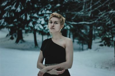Young woman standing in snow