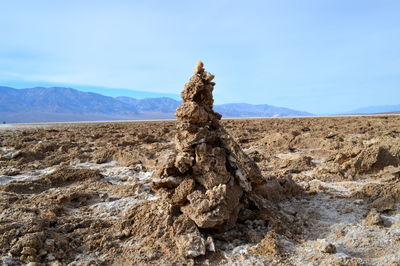 Stack of rock on landscape against sky