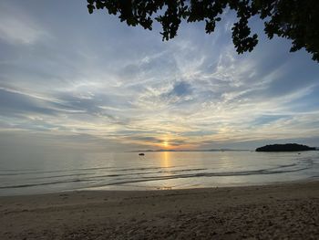 Scenic view of beach against sky during sunset