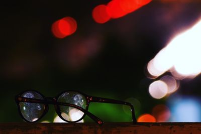 Close-up of illuminated lighting equipment on table