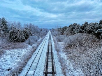 View of railroad tracks against sky during winter