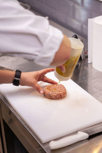 Cropped hand of person preparing food