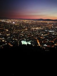 High angle view of illuminated buildings against sky at night