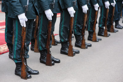 Low section of soldiers holding weapons