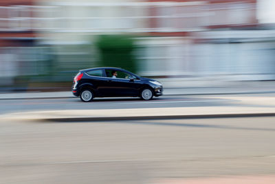 Blurred motion of car moving on road