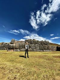 Man standing on field against sky