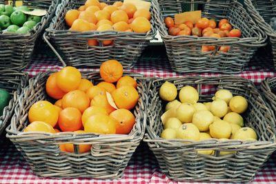 Close-up of fruits in baskets at market stall