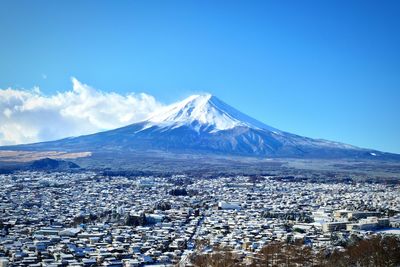 Scenic view of mountains against blue sky