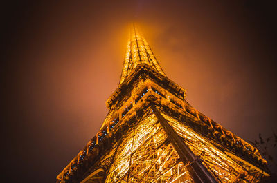 Low angle view of illuminated building against sky