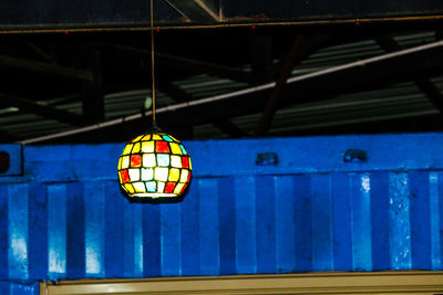 Close-up of illuminated pendant lights hanging on ceiling