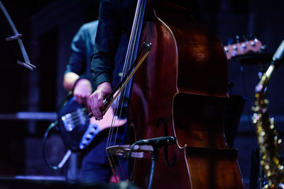 Midsection of artists playing instruments during concert