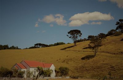 Scenic view of trees and houses against sky