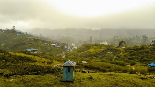 House on mountain against sky