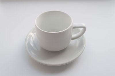 Close-up of coffee cup over white background