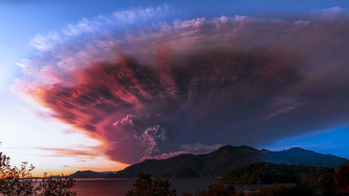 Low angle view of silhouette mountain against dramatic sky