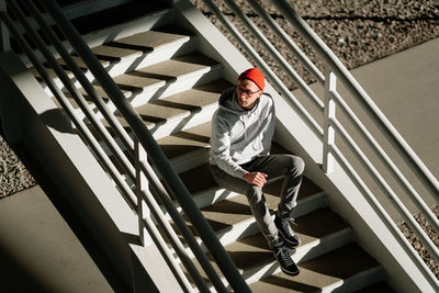 High angle view of man sitting on staircase