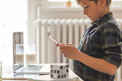 Side view of man using mobile phone