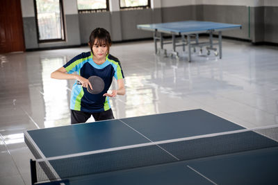 Portrait of boy playing tennis