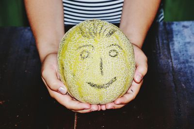 Midsection of woman holding melone 