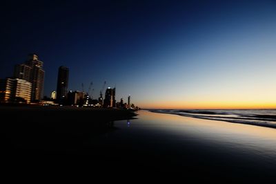 View of city at waterfront during sunset