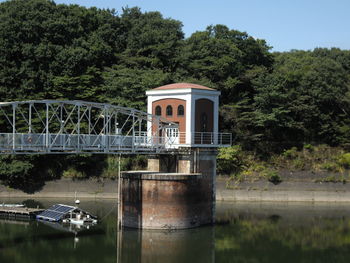 View of bridge over river against trees