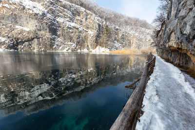 Scenic view of lake against sky during winter