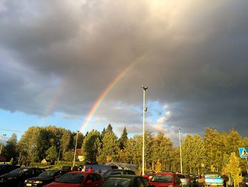 Low angle view of rainbow over road against sky