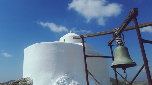 Low angle view of wind turbine against blue sky