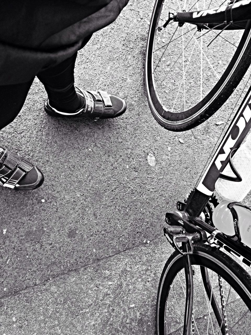 low section, bicycle, transportation, person, land vehicle, mode of transport, shoe, street, part of, men, high angle view, cycling, riding, leisure activity, lifestyles, human foot, cropped