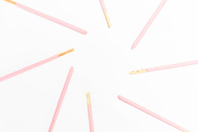 High angle view of colored pencils on white background