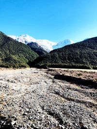 Scenic view of mountains against clear blue sky