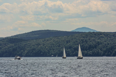 Sailboat sailing on sea against sky