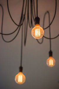 Low angle view of illuminated light bulbs